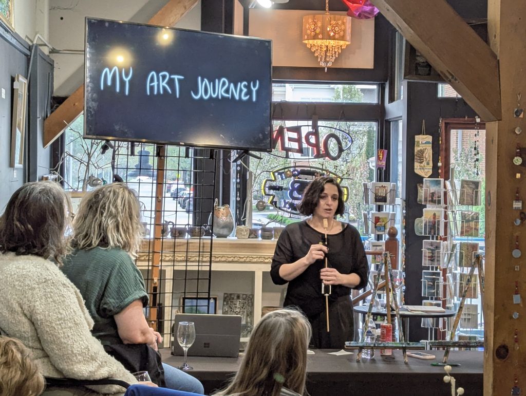 A photograph of Keighley Stadler presenting her art journey to the Art Guild of Menomonee Falls on April 28, 2026.