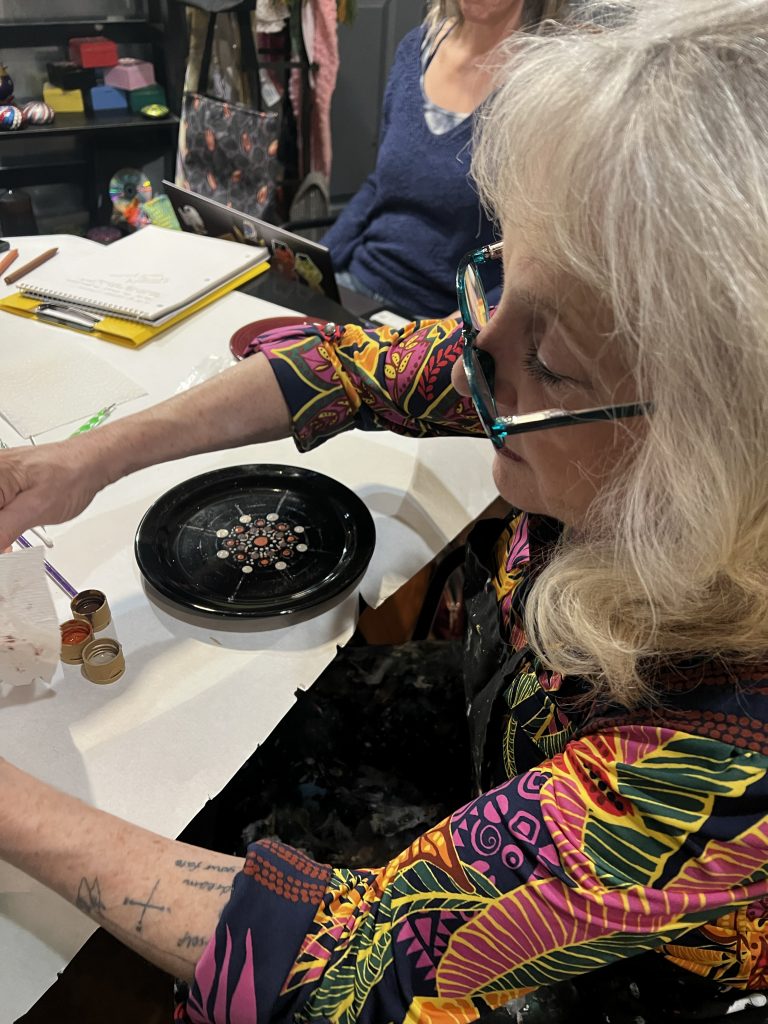Photo of Art Guild member Eileen participating in The Dotting Chick's workshop during the March member meeting.